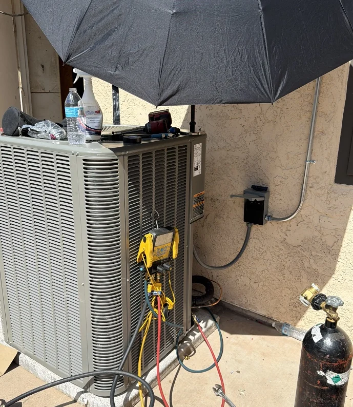 Service gauges connected to an outdoor central AC condenser