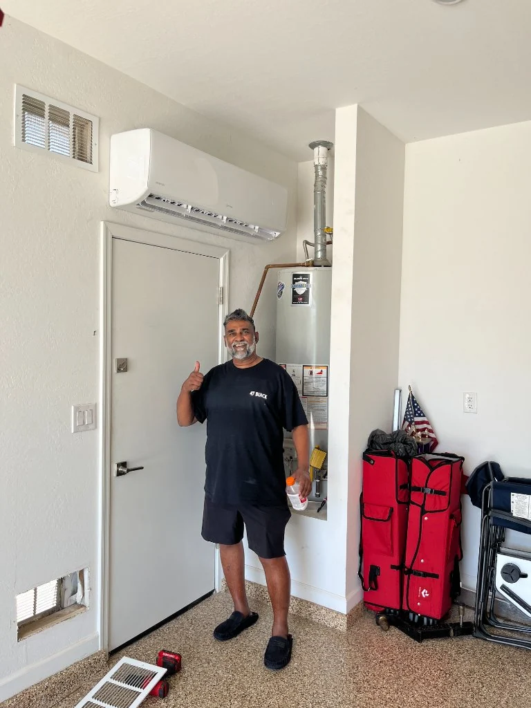Homeowner beside a wall-mounted mini-split