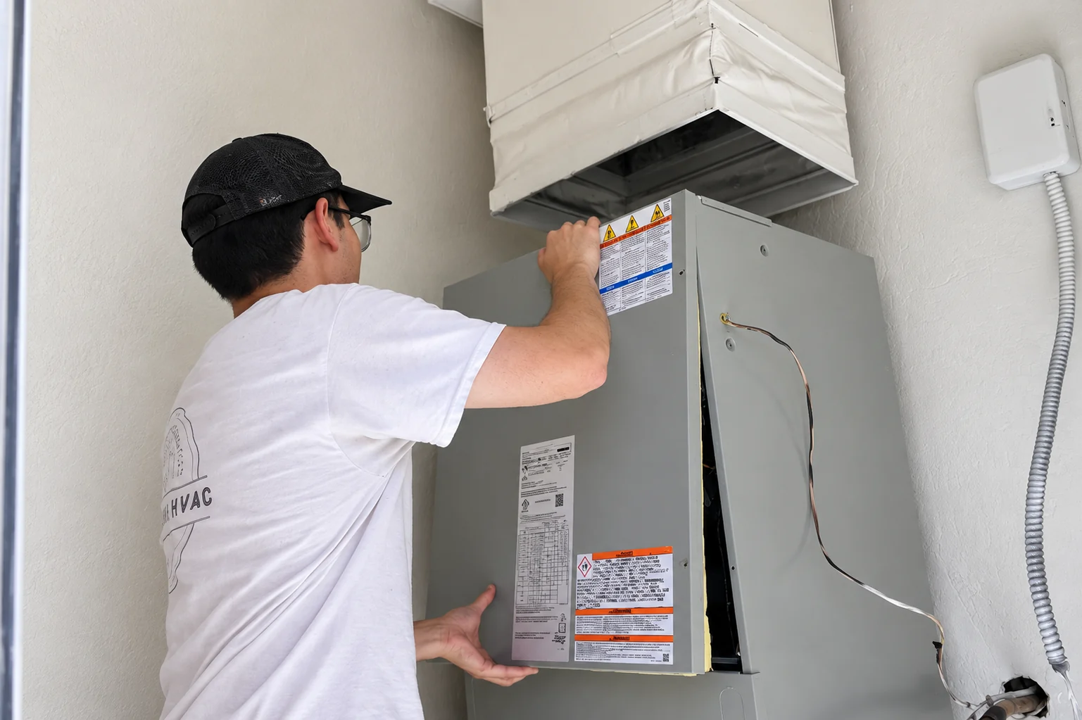 Core Comfort technician installing an indoor central HVAC air handler