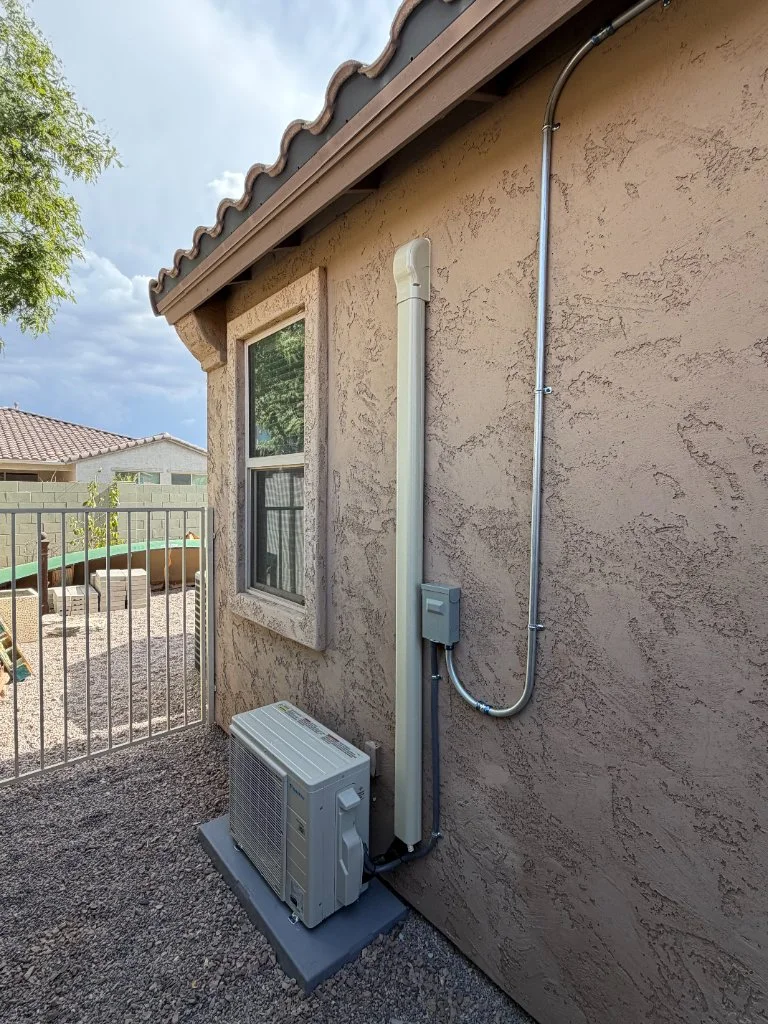 Outdoor mini-split condenser with refrigerant line routing