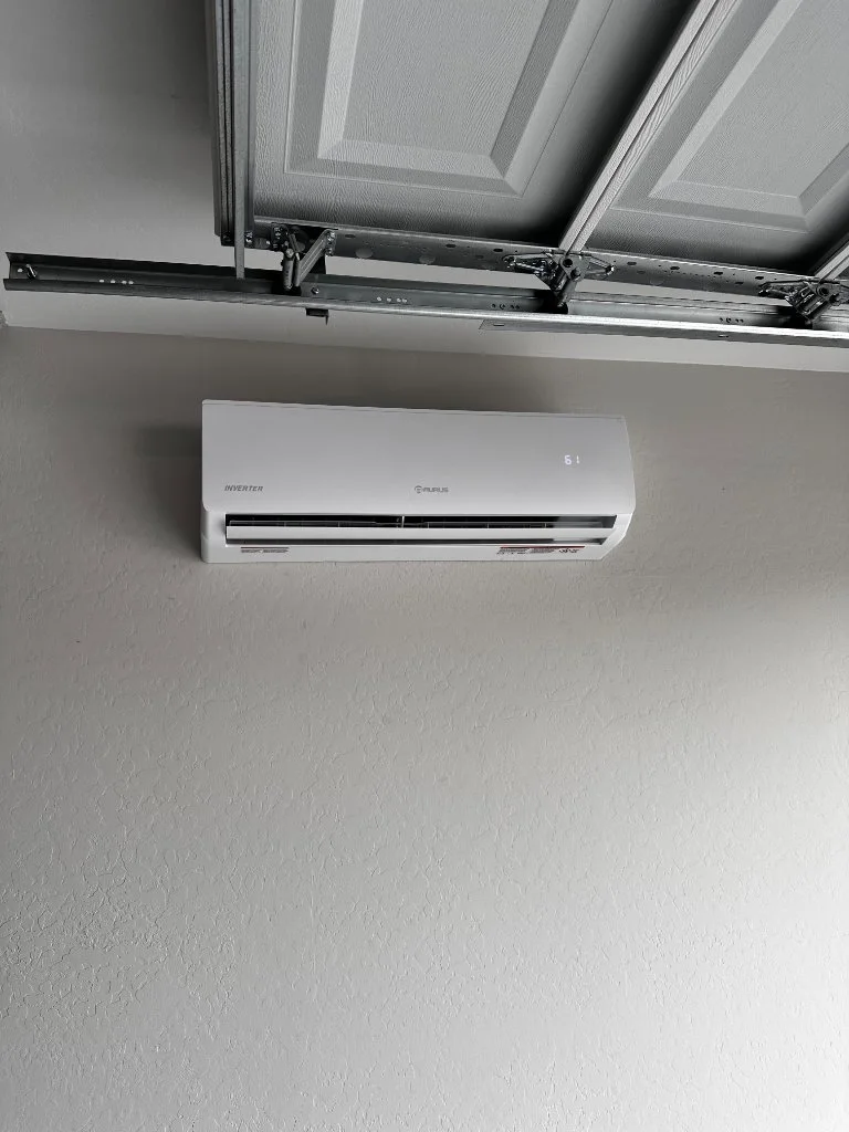 Wall-mounted mini-split above a garage door
