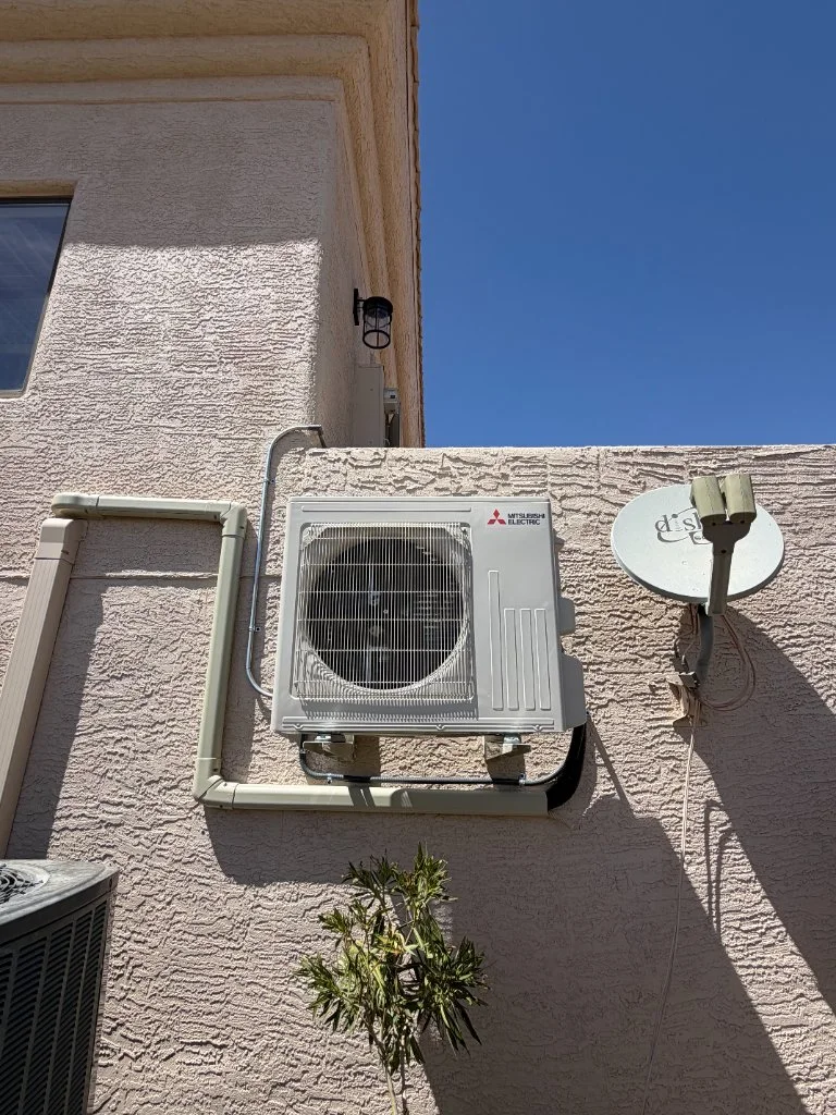 Outdoor mini-split condenser with refrigerant line routing