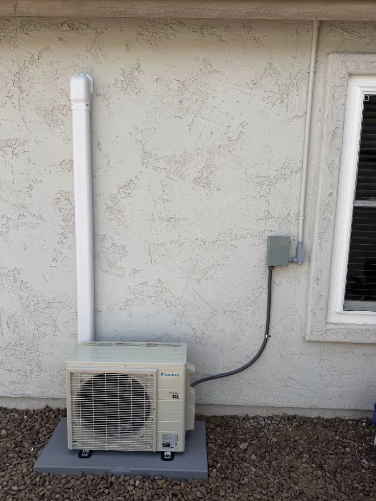 Outdoor mini-split condenser with refrigerant line routing