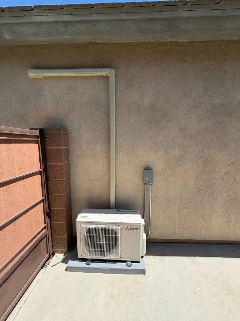 Outdoor mini-split condenser with refrigerant line routing