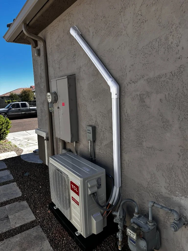 Outdoor mini-split condenser with refrigerant line routing