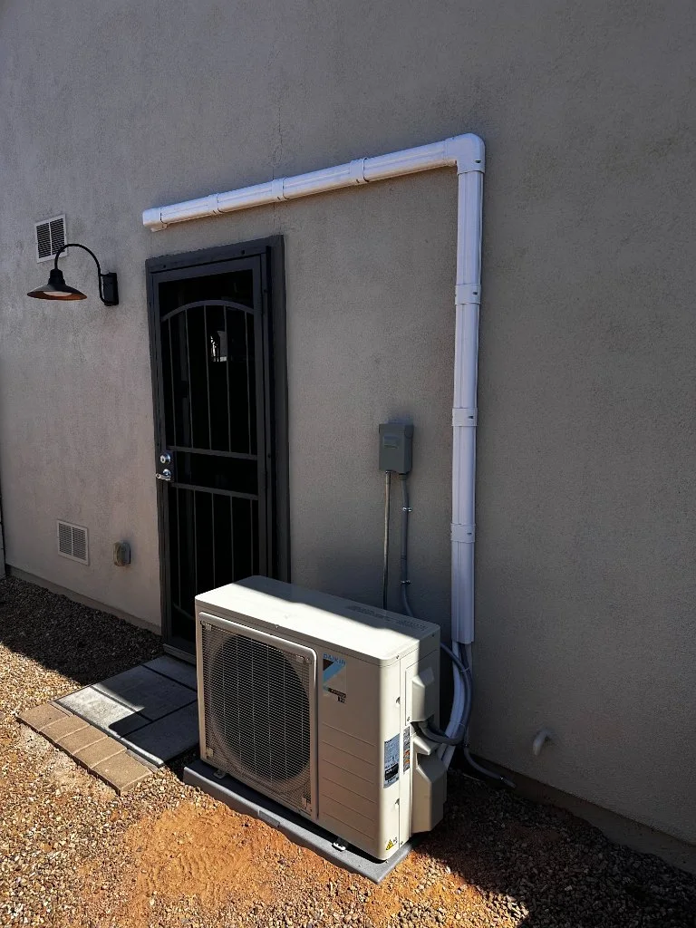 Outdoor mini-split condenser with refrigerant line routing