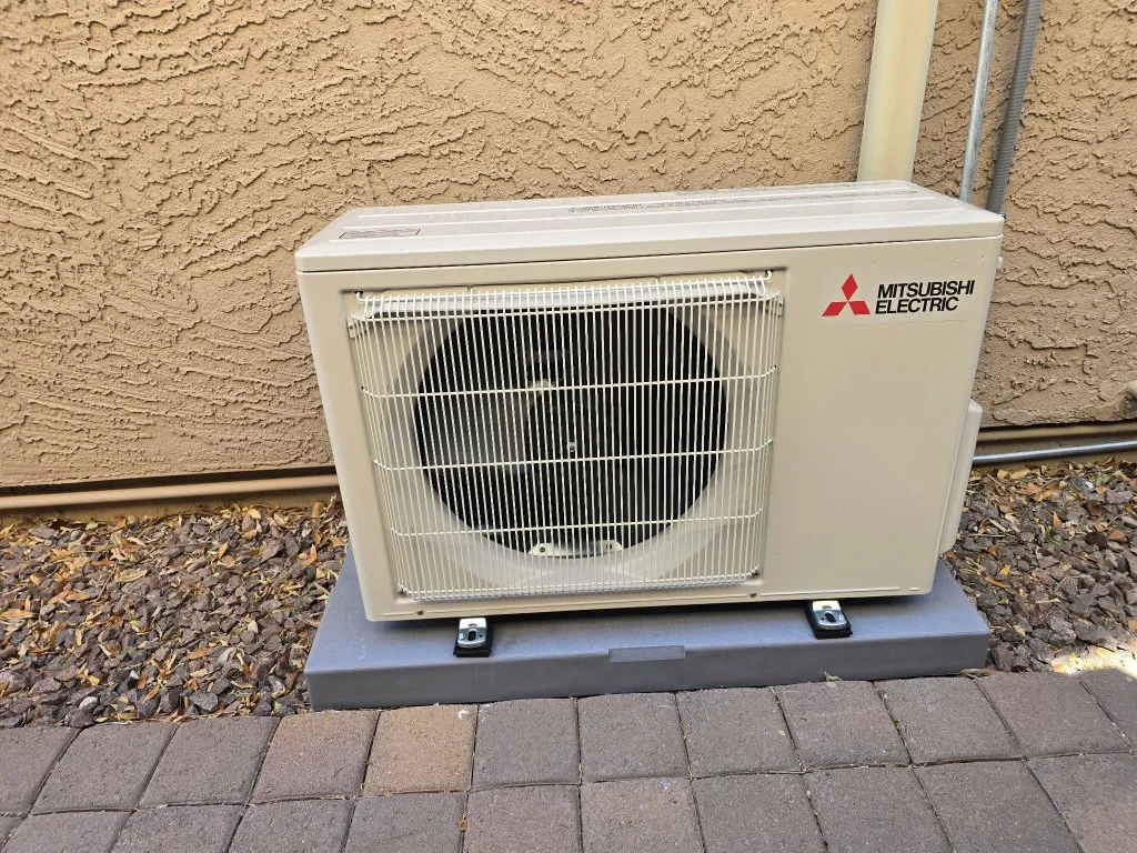Outdoor mini-split condenser with refrigerant line routing