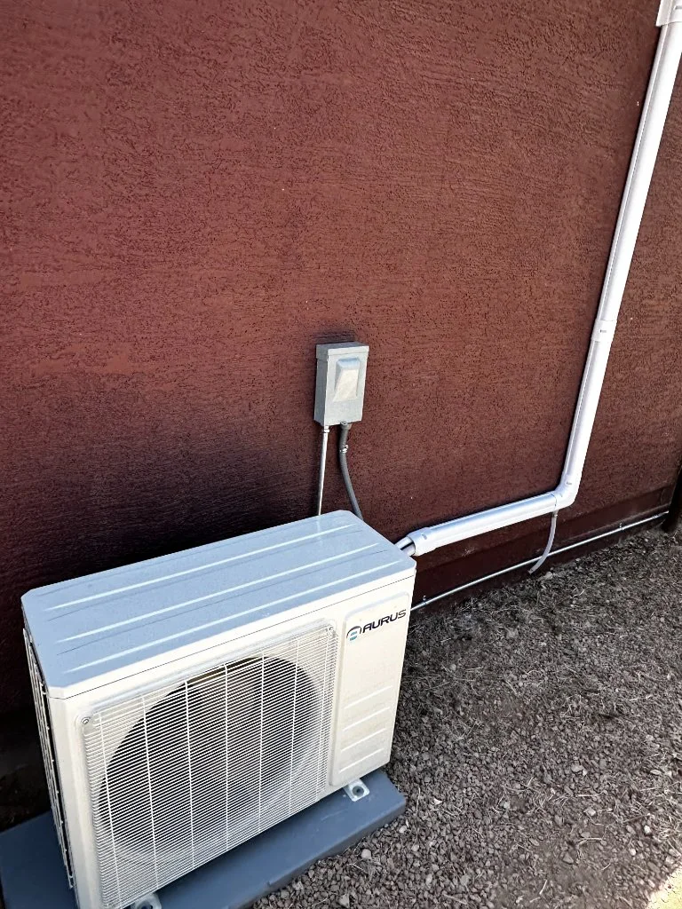 Outdoor mini-split condenser with refrigerant line routing