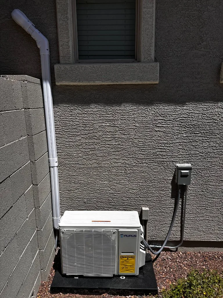 Outdoor mini-split condenser with refrigerant line routing