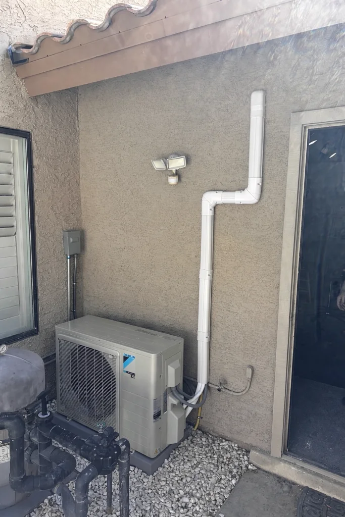 Outdoor mini-split condenser with refrigerant line routing