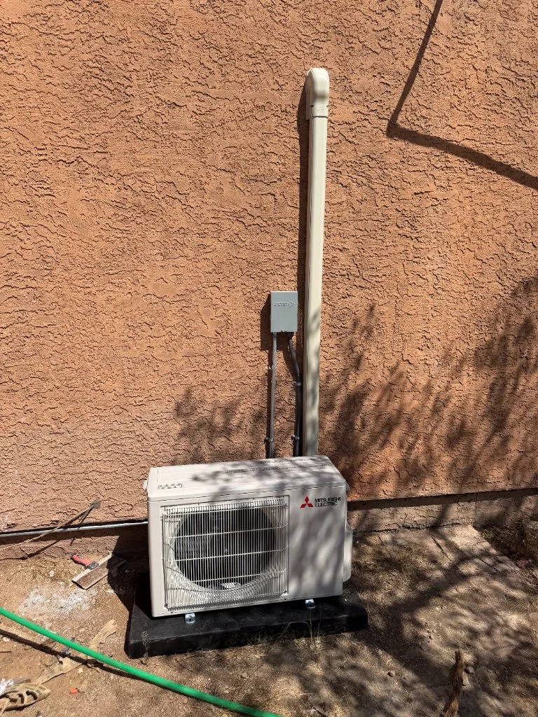 Outdoor mini-split condenser with refrigerant line routing