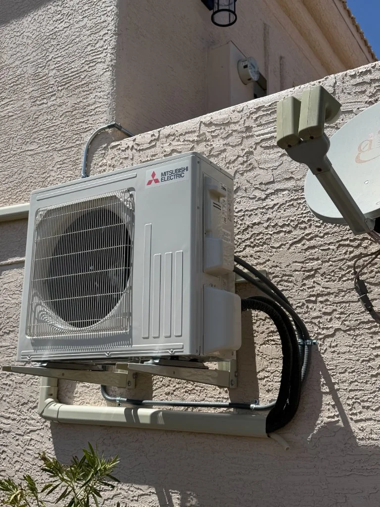 Outdoor mini-split condenser with refrigerant line routing