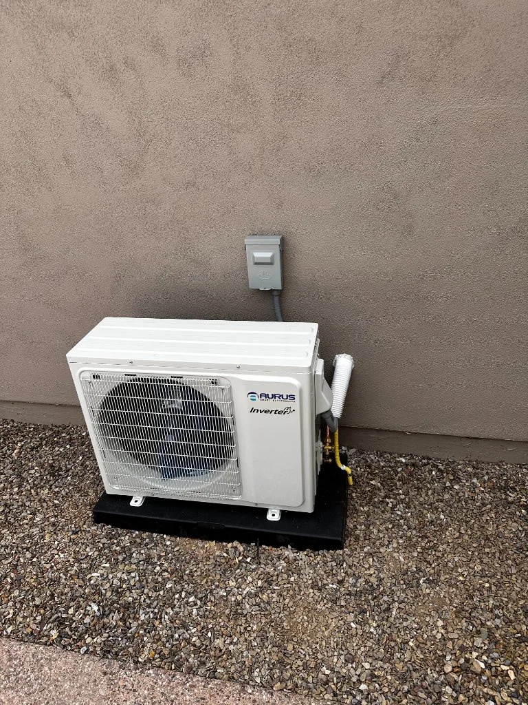 Outdoor mini-split condenser with refrigerant line routing