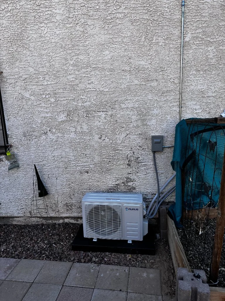 Outdoor mini-split condenser with refrigerant line routing