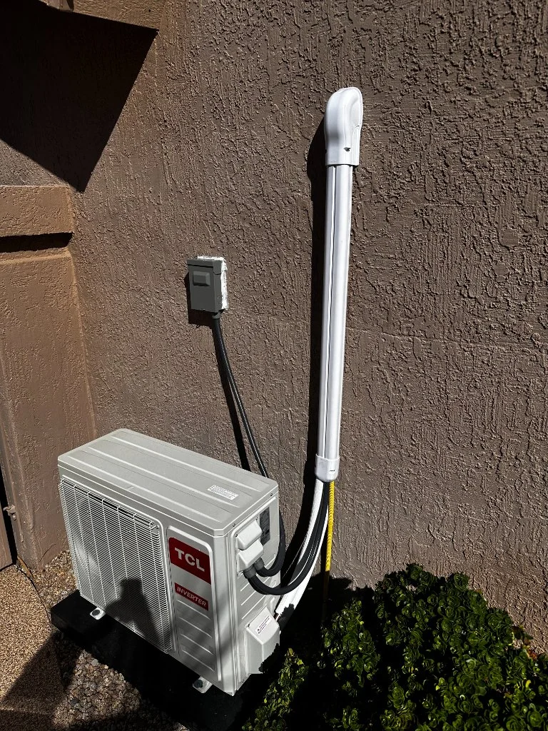 Outdoor mini-split condenser with refrigerant line routing